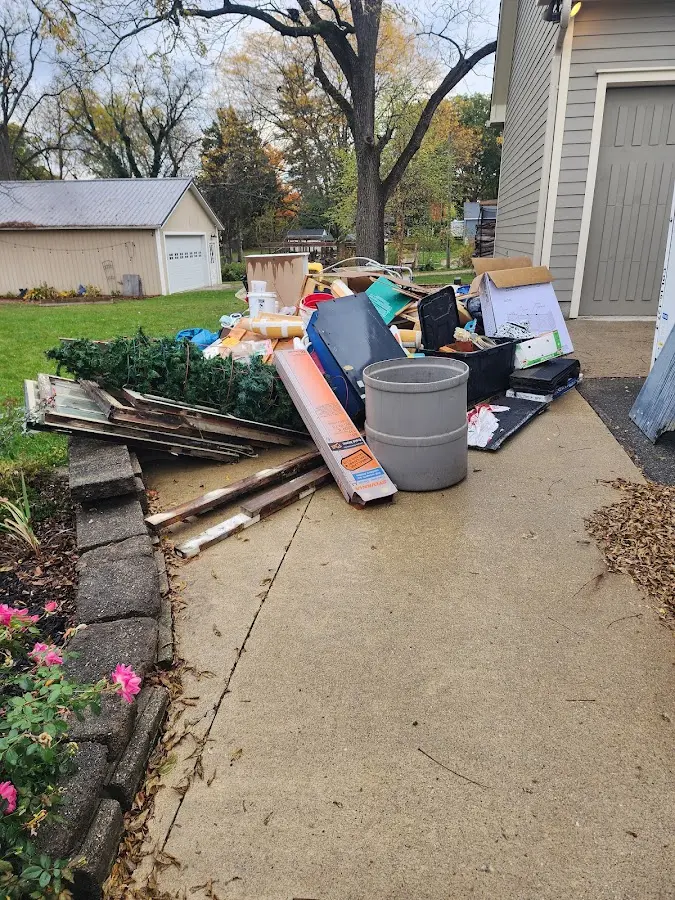 Dumpster being loaded with debris for 12 Yard Dumpster Rental in Titusville